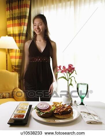 Room service cheeseburger meal with flowers and Taiwanese mid adult woman in background. View Large Photo Image Stock Image - Room service cheeseburger meal with flowers and Taiwanese mid adult woman in background.. Fotosearch