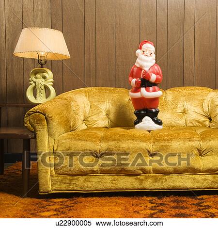Stock Photography - Santa clause figurine on retro style couch. Fotosearch