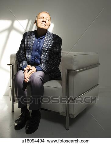 Picture - Senior adult male sitting in chair. Fotosearch