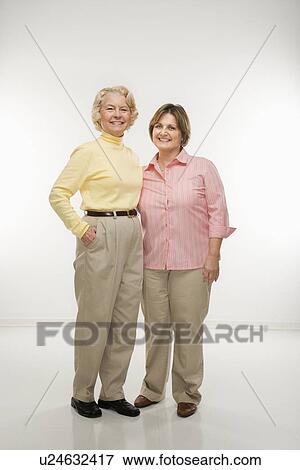 Senior woman and middle aged woman standing together View Large Photo Image Stock Photo - Senior woman and middle aged woman standing together. Fotosearch