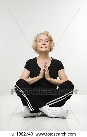 Senior woman sitting in yoga position on floor meditating. View Large Photo Image Stock Image - Senior woman sitting in yoga position on floor meditating.. Fotosearch