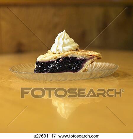Stock Photo - Slice of blueberry pie on plate with whipped topping. Fotosearch