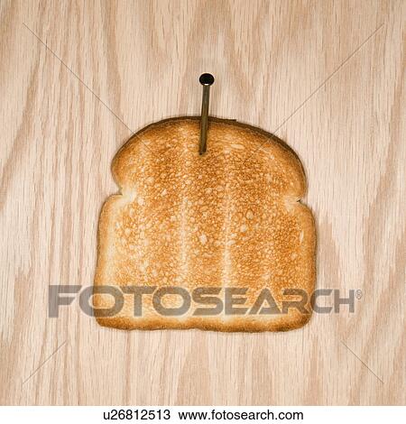 Slice of toast nailed to wood View Large Photo Image Stock Image - Slice of toast nailed to wood. Fotosearch