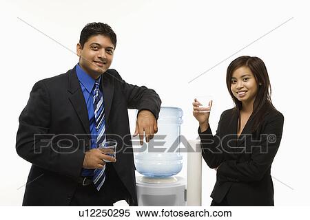 Standing at water cooler View Large Photo Image Stock Photography - Standing at water cooler . Fotosearch