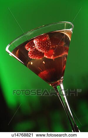 Still life of martini cocktail with raspberries fruit against glowing green background View Large Photo Image Stock Image - Still life of martini cocktail with raspberries fruit against glowing green background. Fotosearch