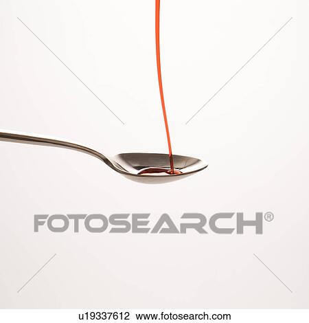 Stream of red cough syrup being poured into spoon View Large Photo Image Stock Image - Stream of red cough syrup being poured into spoon. Fotosearch