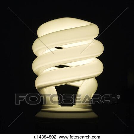 Stock Image - Studio shot of illuminated energy saving light bulb. Fotosearch