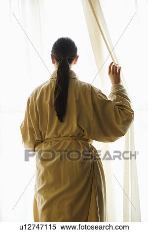 Taiwanese mid adult woman in bathrobe looking out window. View Large Photo Image Stock Photography - Taiwanese mid adult woman in bathrobe looking out window.. Fotosearch