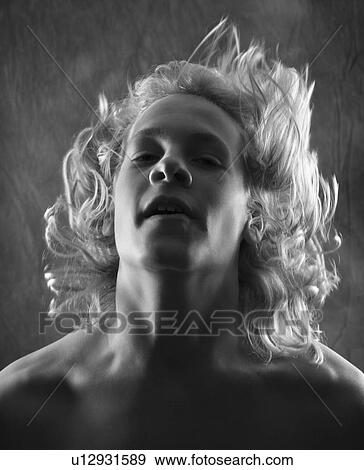 Stock Photo - Teen boy flipping hair back.. Fotosearch