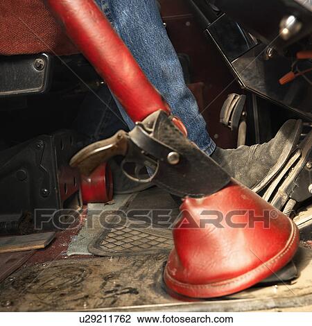Stock Image - Tractor trailer with gun and holster attached to gear shift. Fotosearch