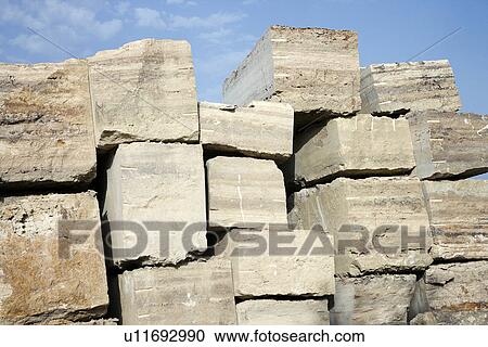 Stock Image - Travertine stone excavated from open mine quarry. Fotosearch