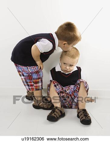 Twin boy kissing other twin boy on head View Large Photo Image Stock Photograph - Twin boy kissing other twin boy on head. Fotosearch