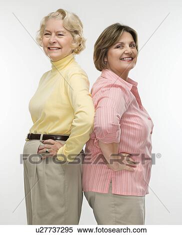 Stock Photography - Woman and woman standing back to back. Fotosearch
