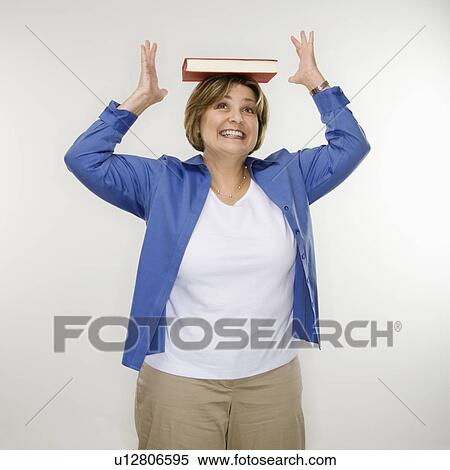 Stock Photography - Woman balancing book on head. Fotosearch