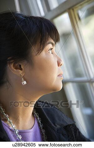 Stock Photography - Woman gazing out window. Fotosearch