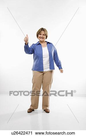 Stock Image - Woman giving thumbs up and smiling . Fotosearch