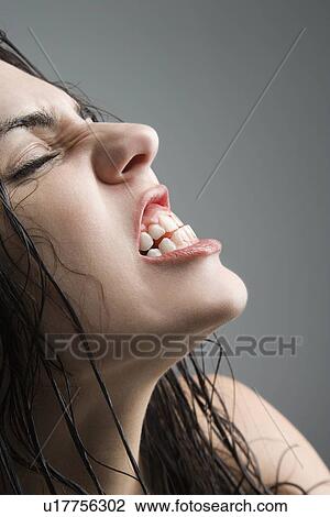woman grimacing with eyes closed View Large Photo Image Stock Image - woman grimacing with eyes closed. Fotosearch