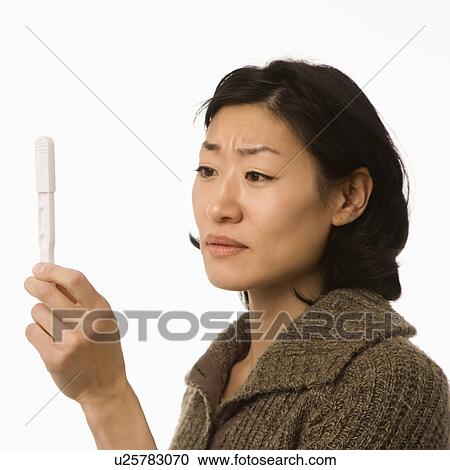 Woman holding up pregnancy test View Large Photo Image Stock Image - Woman holding up pregnancy test. Fotosearch