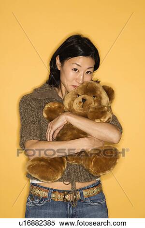 Woman hugging brown teddy bear View Large Photo Image Stock Photography - Woman hugging brown teddy bear. Fotosearch