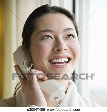 Woman in bathrobe talking on phone and smiling View Large Photo Image Stock Photography - Woman in bathrobe talking on phone and smiling. Fotosearch