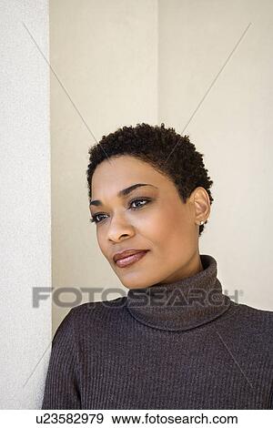 Stock Photo - Woman leaning against wall . Fotosearch