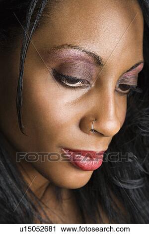 Stock Image - woman looking down.. Fotosearch