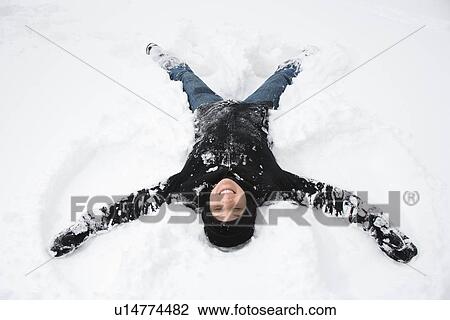 Woman making a snow angel View Large Photo Image Stock Image - Woman making a snow angel . Fotosearch