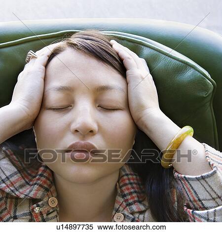 Stock Photography - Woman sitting in green chair. Fotosearch