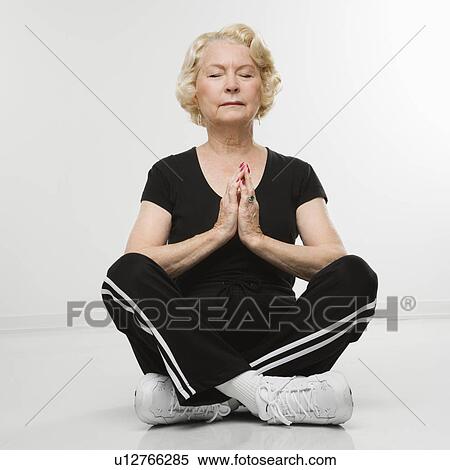 Woman sitting in yoga position on floor meditating View Large Photo Image Stock Photography - Woman sitting in yoga position on floor meditating. Fotosearch