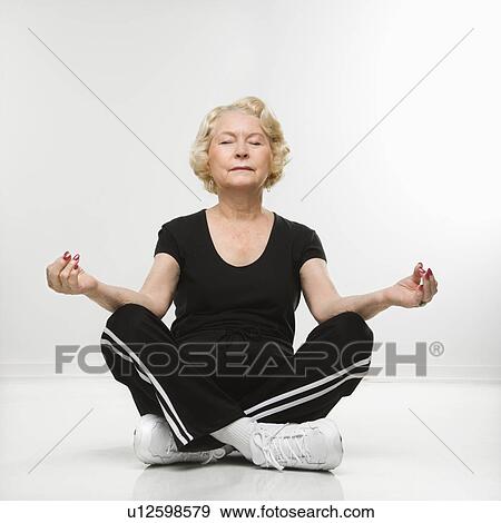 Woman sitting in yoga position View Large Photo Image Stock Photo - Woman sitting in yoga position. Fotosearch