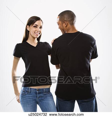 Stock Image - Woman smiling with hand on man's shoulder. Fotosearch