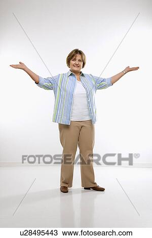 Stock Image - Woman standing with arms in the air . Fotosearch