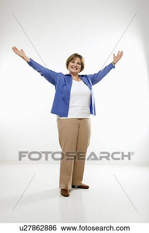 Woman standing with arms in the air View Large Photo Image Stock Photograph - Woman standing with arms in the air . Fotosearch
