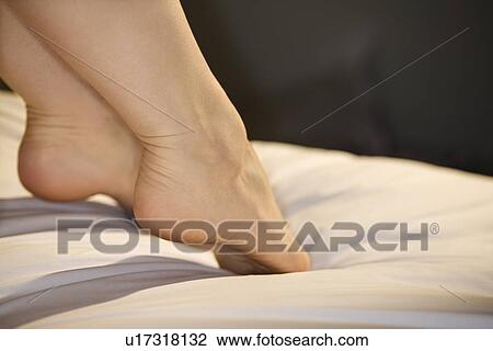 woman's outstretched feet on bed View Large Photo Image Stock Image - woman's outstretched feet on bed. Fotosearch