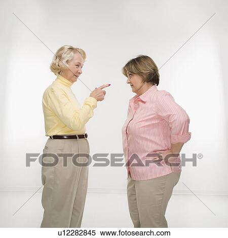 Stock Photography - Women face to face arguing. Fotosearch