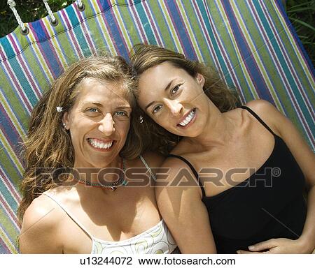 Women laying on a hammock View Large Photo Image Stock Image - Women laying on a hammock. Fotosearch