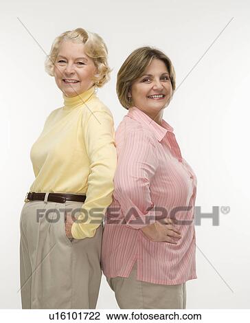 Stock Image - Women standing back to back. Fotosearch