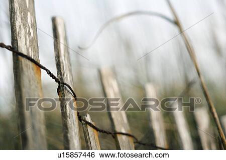 Wooden fence with rusted wiring View Large Photo Image Stock Photograph - Wooden fence with rusted wiring. Fotosearch