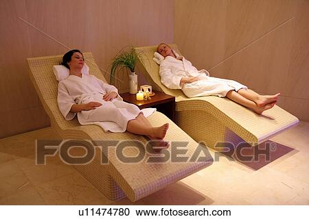 Two young women relaxing at a spa together View Large Photo Image Stock Image - Two young women relaxing at a spa together. Fotosearch