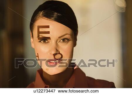 Woman with optical exam characters on her face View Large Photo Image Stock Photo - Woman with optical exam characters on her face. Fotosearch