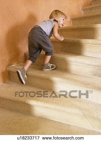 Stock Photo - Little girl climbing up the stairs.. Fotosearch