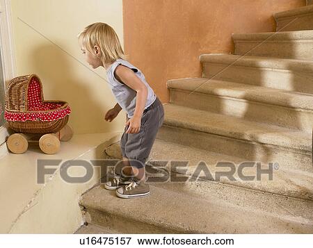 Stock Photo - Little girl looking at her stroller.. Fotosearch