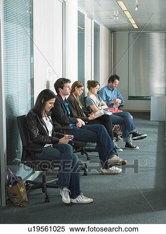 Stock Photography - Patients sitting in waiting room of a hospital.. Fotosearch