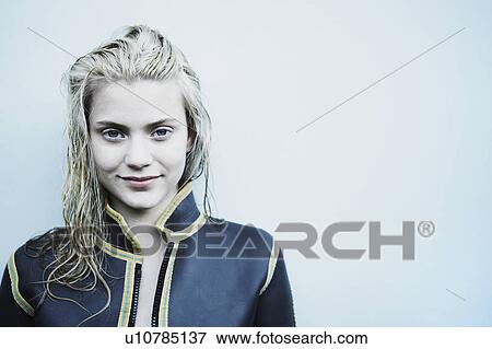 Stock Photo - Portrait of young woman in wet suit.. Fotosearch