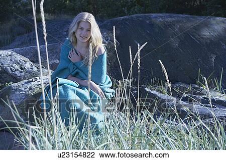 Stock Image - Young Woman wrapped in blanket.. Fotosearch
