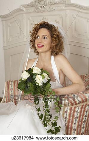 young bride smiling sitting holding bridal bouquet View Large Photo Image Picture - young bride smiling sitting holding bridal bouquet. Fotosearch