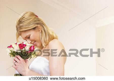 A bride smelling her bouquet View Large Photo Image Stock Image - A bride smelling her bouquet. Fotosearch