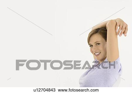 A woman relaxing with her arms up View Large Photo Image Stock Image - A woman relaxing with her arms up. Fotosearch
