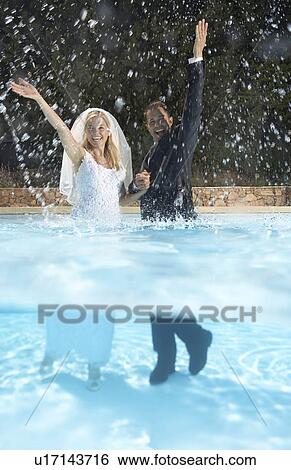 Bride and groom in pool View Large Photo Image Stock Photograph - Bride and groom in pool. Fotosearch