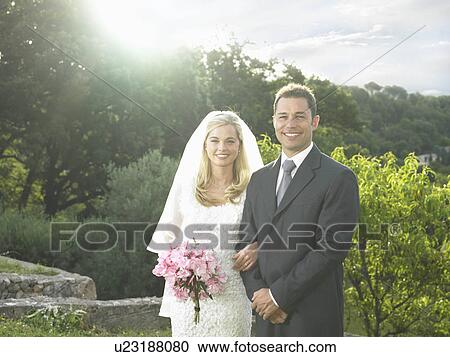 Stock Image - Bride and groom in sunshine. Fotosearch